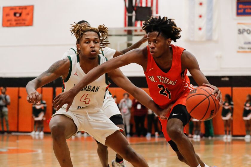 Young’s DJ Steward (21) drives the ball past Morgan Park’s Isaiah Burrell (4).