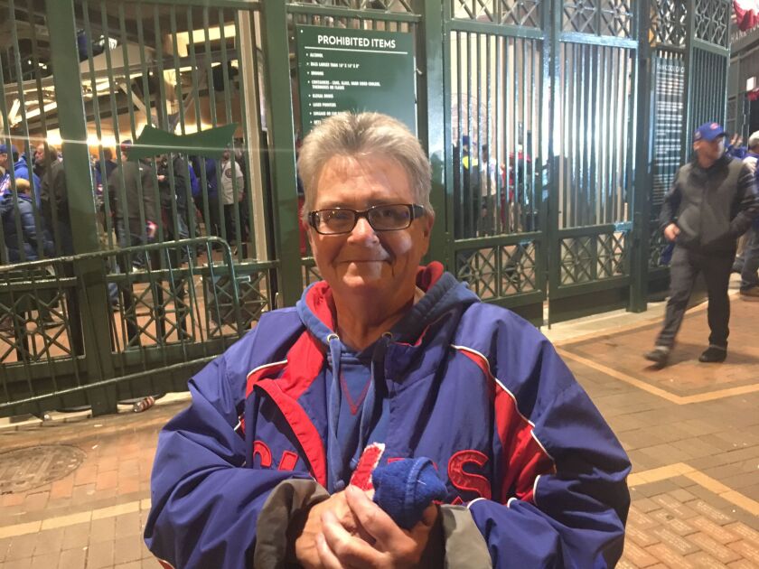 “This is for my dad,” Judy Burke said of the Cubs’ win. She was among many fans elated over the victory but saddened that a relative who loved the team hadn’t lived long enough to see the Cubs in the World Series. | Mitch Dudek / Sun-Times