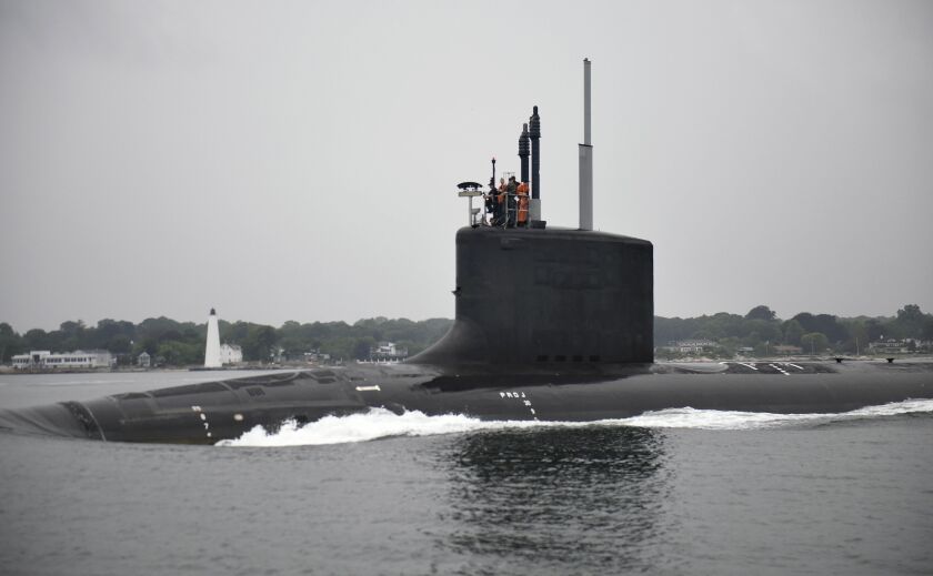 In this July 29, 2016 photo provided by General Dynamics Electric Boat, the submarine USS Illinois travels along the Thames River after departing General Dynamics Electric Boat in Groton, Conn., for initial sea trials. | Gary Slater/General Dynamics Elect