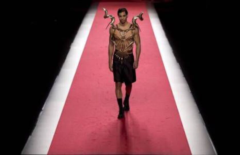 A model displays an Autumn/Winter design by Francis Montesinos at Madrid’s Fashion Week in Madrid, Spain, Sunday, Feb. 8, 2015 . (AP Photo/Daniel Ochoa de Olza)