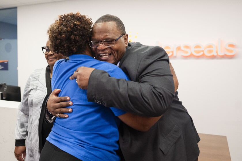 Nazareth Wilson hugs Crystal Odom-McKinney, of Easterseals.