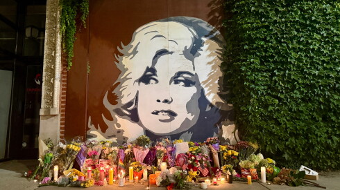 A makeshift memorial appears by a Dolly Parton mural in Edgewater, following news of the beloved star's death at 80 on Tuesday.