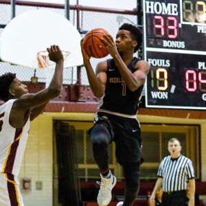 Solorio’s Sincere Key (1) goes to the basket against Lindblom’s Marshun Williams (35).