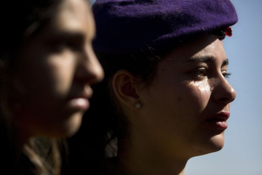 Israeli soldiers cry during the funeral of Major Yochai Kalangel in Jeruslaem, Thursday, Jan. 29, 2015. Israeli Prime Minister Benjamin Netanyahu on Thursday said that Iran is to blame for a deadly flare-up along the Israeli-Lebanese border the previous d