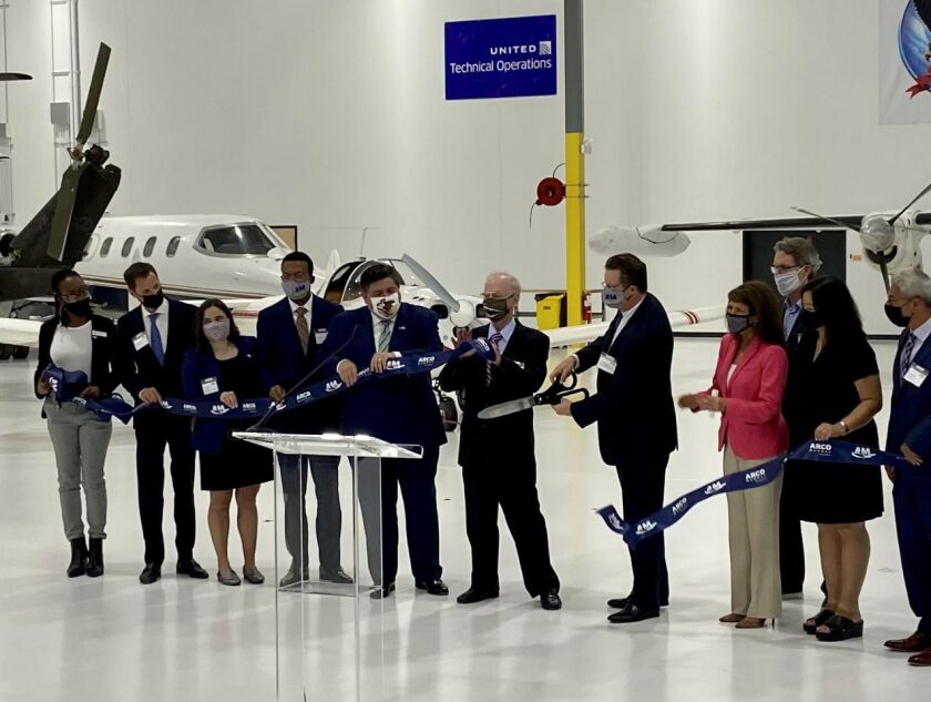 Gov. J.B. Pritzker, fifth from left, joins elected and industry officials at the ribbon-cutting ceremony at the Aviation Institute of Maintenance’s new training center, at 3711 S. Ashland on Wednesday.
