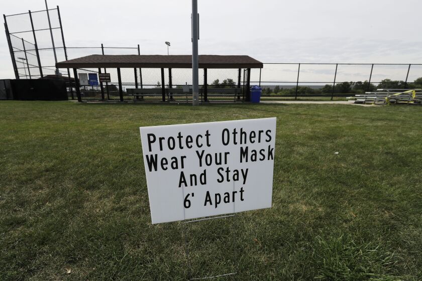 A sign warns people to follow COVID-19 precautions at Vernon Hills Athletic Complex in Vernon Hills on Thursday.