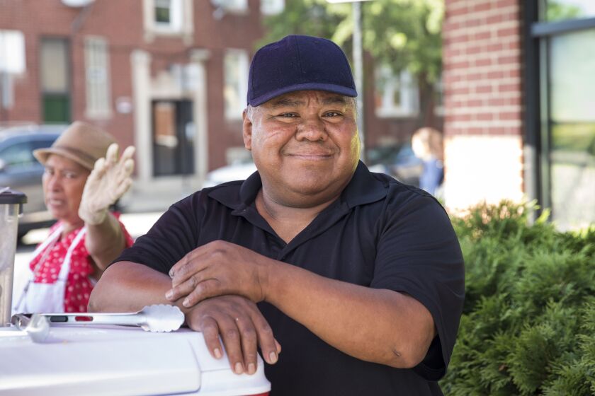 Felipe Vallarta, 58, an elotero, serves corn from his Rogers Park stand in 2018.