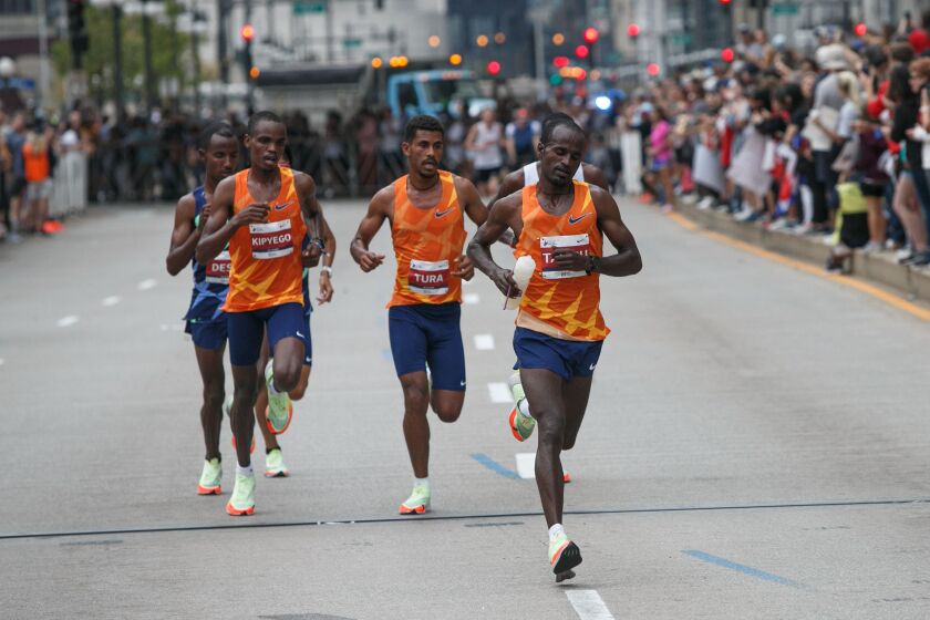 The first wave of runners head along Wacker Drive early in the Chicago Marathon on Sunday. Oct. 10, 2021.