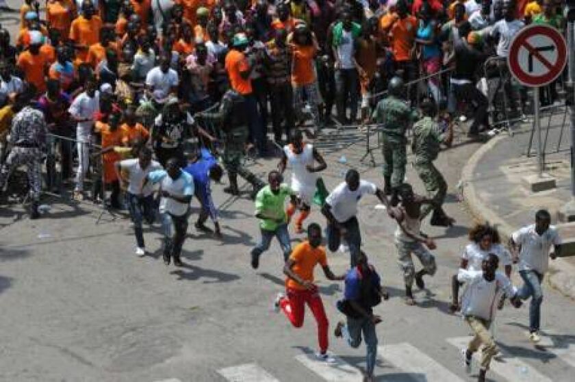 Supporters of Ivorian football national team force a police barrier to enter the Houphouet Boigny stadium in Abidjan on February 9, 2015 to welcome their team a day after its victory over Ghana in the 2015 African Cup of Nations final. SIA KAMBOU/AFP/Gett