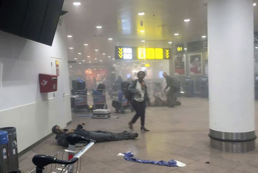 In this photo provided by Georgian Public Broadcaster and photographed by Ketevan Kardava a man is wounded in Brussels Airport in Brussels, Belgium, after explosions on Tuesday. All flights were canceled, arriving planes were being diverted and Belgium’s