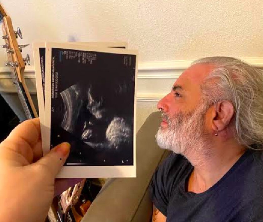 Matthew “Turk” Agostini posed beside an ultrasound photo of his son, who is due to be born on Christmas Day. He’ll have his father’s nose.