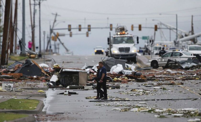 Debris from a storm covers a street in Tulsa on Sunday. | Tom Gilbert/Tulsa World via AP