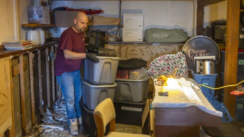 Workers with Restore Construction dispose attempt to clean up and dispose of water damaged belongings of Lorraine Runge’s Norwood Park home on , Wednesday, April 15, 2026 after a major storm rolled through the Chicago area overnight.
