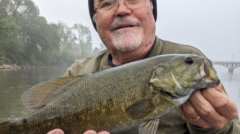The first good smallmouth bass by Dale Bowman in dense fog that started a good morning of fishing the Kankakee River with Matt Mullady.
