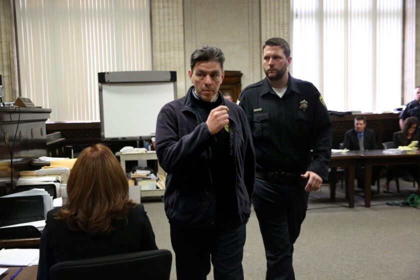 Moises Bernal, left, who was in the courtroom to hear the proceedings, was held in contempt by Judge Vincent Gaughan after snapping his fingers. Bernal told the judge he was in court to see a “racist murderer” go to jail at the George Leighton Criminal Co