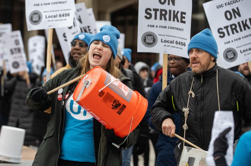 Faculty and their supporters march during a strike at the University of Illinois Chicago in the Little Italy neighborhood, Tuesday, Jan. 17, 2023.