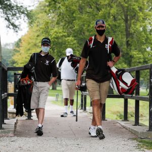 Mount Carmel’s Michael Dobrich walks the course with teammates during practice at Jackson Park Golf Course.
