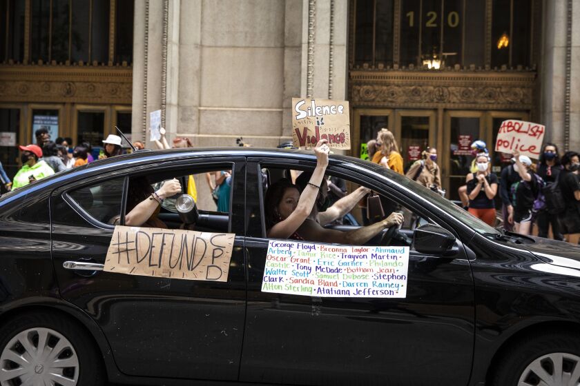 Protesters calling for the city to defund the Chicago Police Department stage a car caravan protest and rally outside City Hall in the Loop, Tuesday afternoon, Aug. 18, 2020. | Ashlee Rezin Garcia/Sun-Times