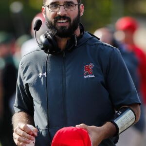 Hinsdale Central coach Brian Griffin walks back to the field after a break during the game against Glenbard West.