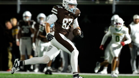 Mount Carmel's Ty Kennedy (87) carries the ball for a touchdown against Providence.