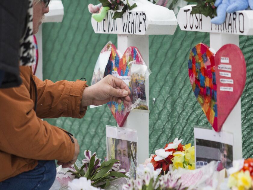 Mourners pay their respects at a memorial for the five people killed two days earlier in a mass shooting at the Henry Pratt Company in Aurora, Sunday afternoon, Feb. 17, 2019. | Ashlee Rezin/Sun-Times