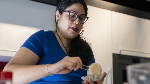 Mia P. Manansala pours mocha mamon batter into cake molds.