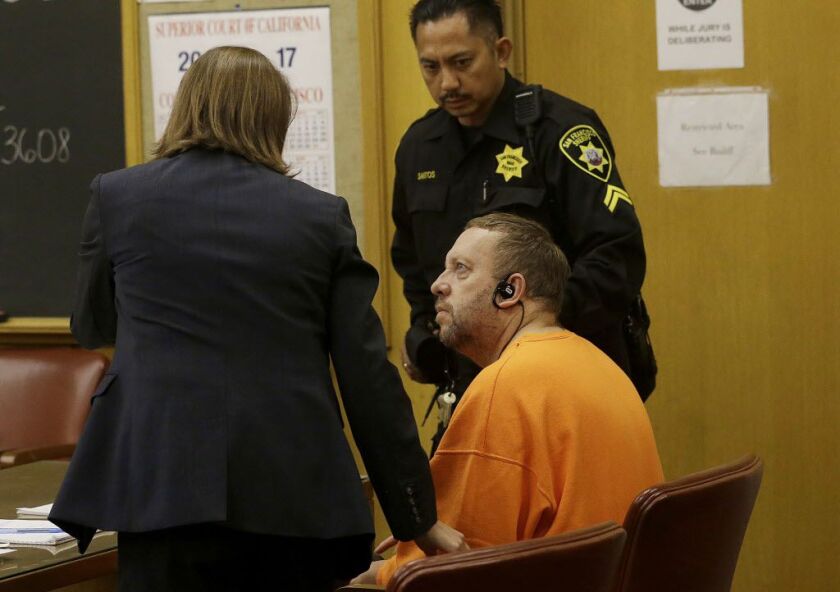 Andrew Warren, bottom, looks toward attorney Ariel Boyce-Smith with the public defender’s office during an extradition hearing at the Hall of Justice in San Francisco Aug. 11, 2017.