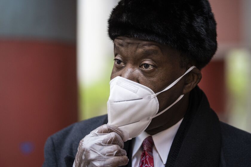 Willie Wilson holds his KN95 face mask out while he speaks to a reporter after joining dozens of pastors and religious leaders for a press conference outside the Thompson Center to call on Gov. J.B. Pritzker to allow churches to reopen amid the ongoing coronavirus pandemic, Thursday morning, May 14, 2020. Several pastors said their churches would be holding mass on Sundays despite the governor’s stay-at-home order.