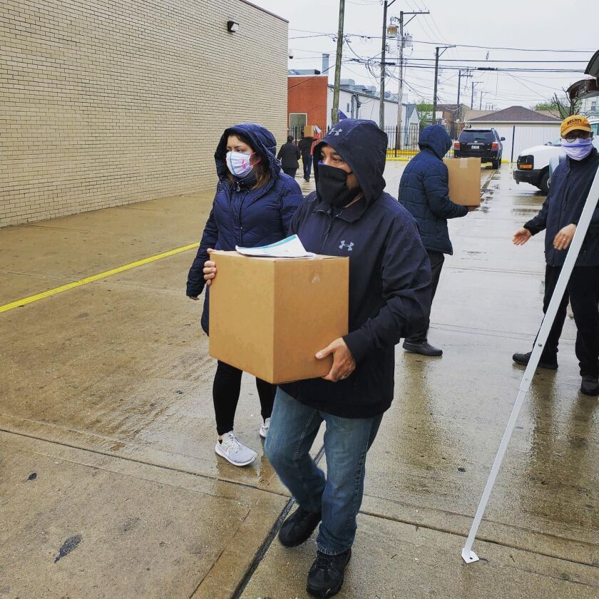 Members of the Gage Park Latinx Council pass out free grocery boxes in Gage Park, May 14, 2020.