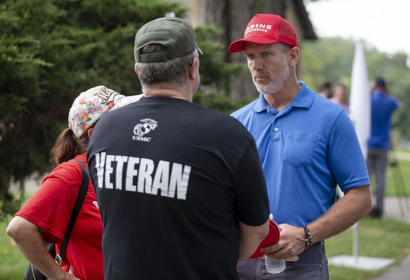 Businessman Gary Rabine, a Republican candidate for Illinois governor, speaks with visitors during Republican Day at the Illinois State Fair on Thursday.