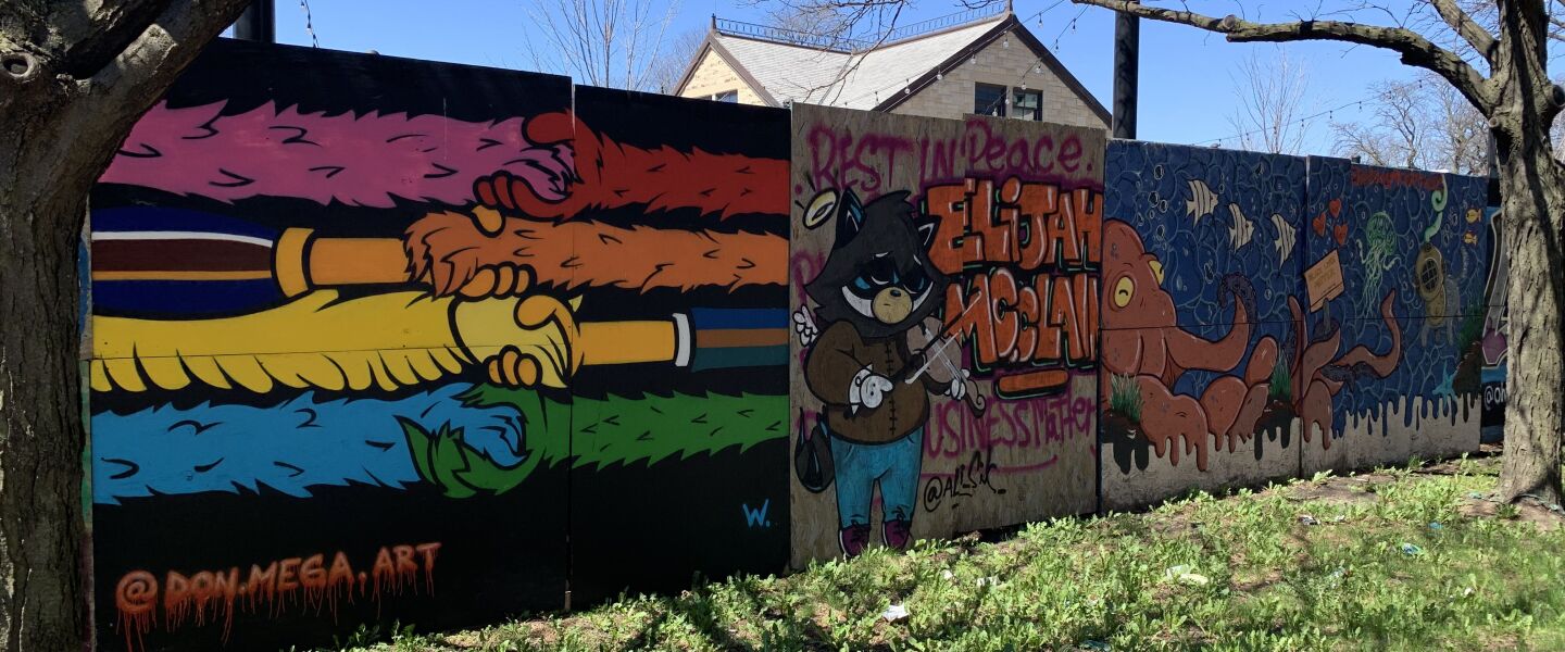 The mural at far left was done by a South Side artist who goes by Don Mega. He says the artwork was a “Sesame Street idea . . . a nice way to represent the idea of coming together.” At the time he painted the boards, they were covering windows at a Loop hotel.