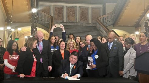 Gov. J.B. Pritzker signs the assault weapons ban at the state Capitol in Springfield on Jan. 10.