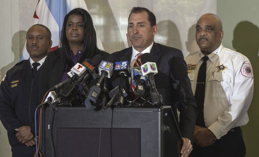 U.S. Attorney John Lausch (at podium) announces federal racketeering charges against five Chicago gang members. Lausch is joined by (from left) 7th District Cmdr. Roderick Robinson, Cook County State’s Attorney Kim Foxx and police Supt. Eddie Johnson. |