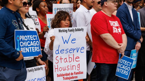 A supporter holds a sign during a press conference to announce the Protect Renters Ordinance (PRO) at Daley Plaza in the loop, Monday, June 29, 2026.