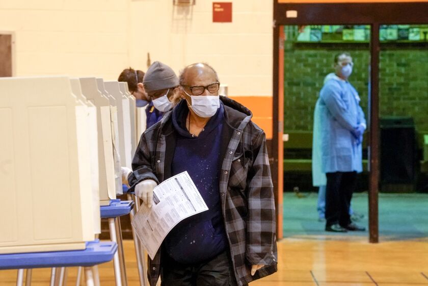 People vote at Riverside High School for Wisconsin’s primary election Tuesday in Milwaukee.