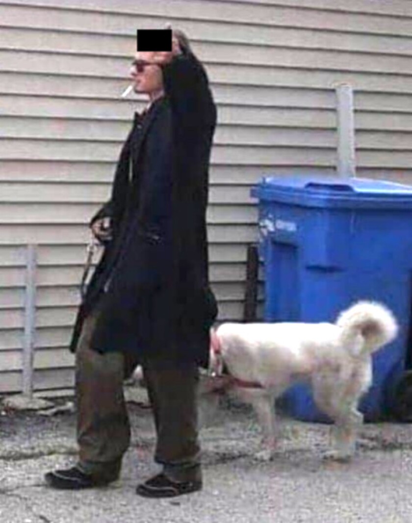 A man, pictured walking a dog, is wanted by the FBI for a hate crime at Lincoln United Methodist Church in Pilsen in 2019.
