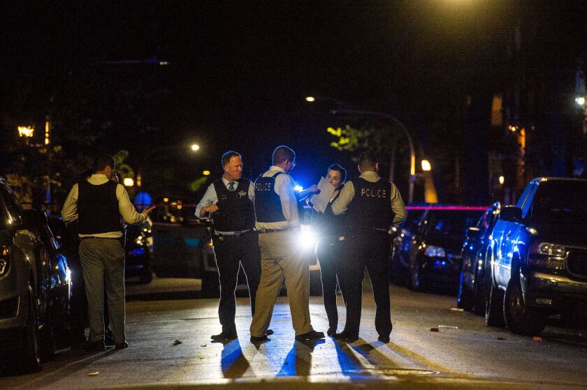 Chicago Police investigate the scene where a man was shot and killed Sunday night in the Garfield Park neighborhood. | Tyler LaRiviere/Sun-Times