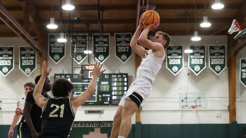 Glenbard East's Danny Snyder (3) shoots a short fade away during the Rams victory over Glenbard North'