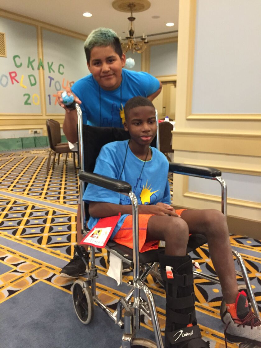 Andres Diaz and Kei’Shaun Hardaway (in chair), both 13, are having fun at Camp Kids Are Kids Chicago, a summer camp for young cancer survivors held this week at the Palmer House Hilton. | Neil Steinberg/Sun-Times