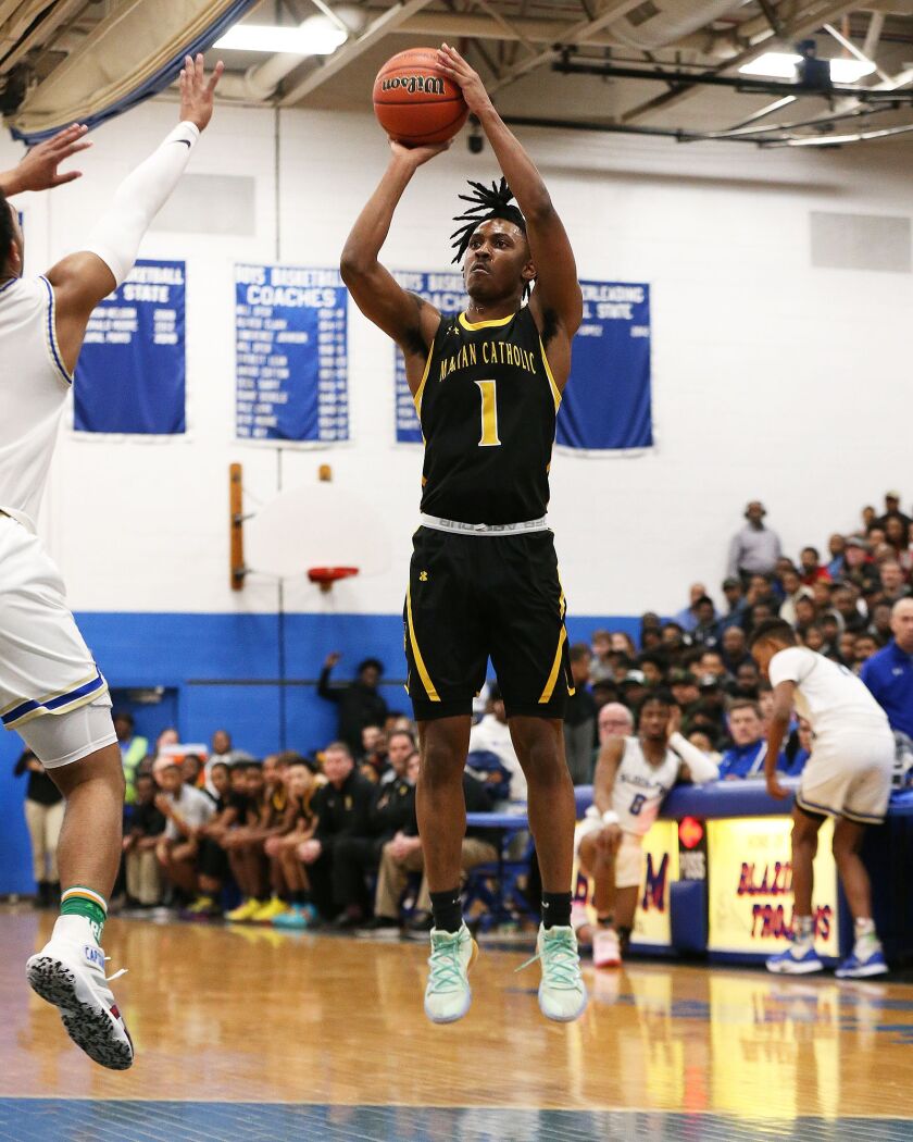 Marian Catholic’s Ahron Ulis (1) rises up for a shot against Bloom.