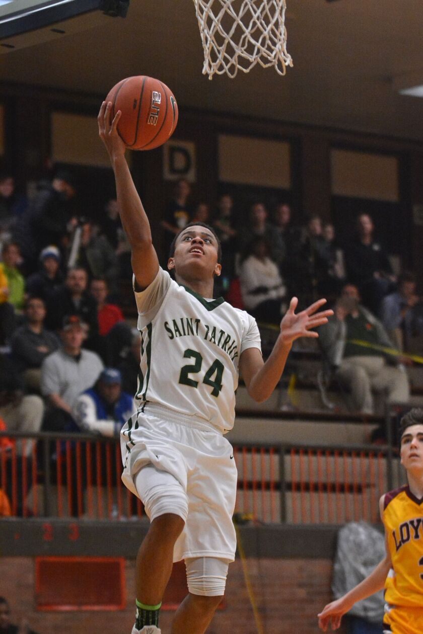 St. Patrick’s Laurence Merritt (24) gets a steal and drives straight to the basket against Loyola in 2017.