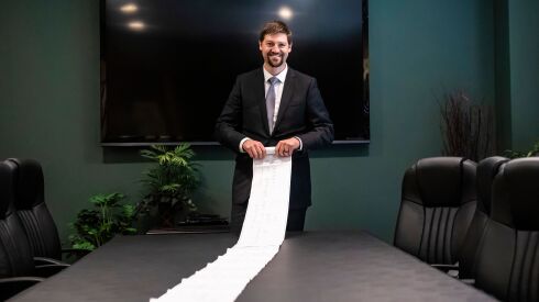 Attorney Ken Piercey unrolls an heir tree showing more than 119 heirs in the $11 million estate of Joseph Stancak, a Chicagoan who died with no will and no immediate relatives.