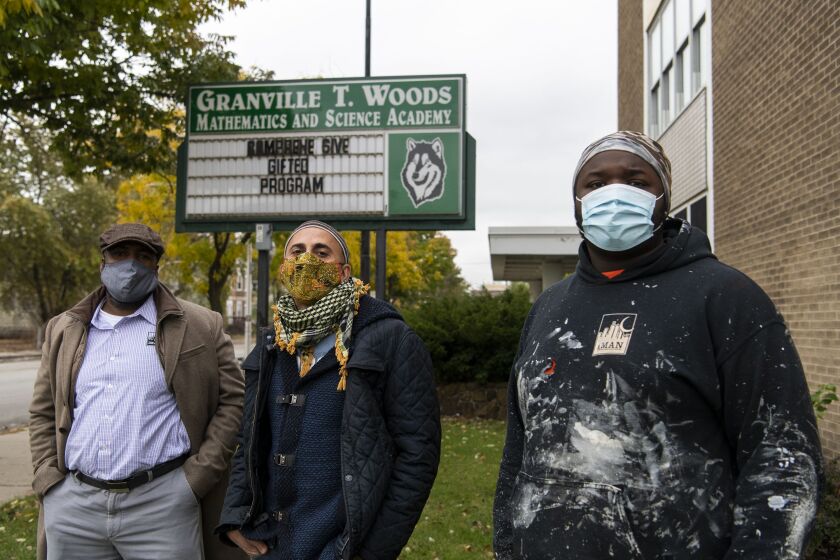 Michael Nash (right) stands with Rami Nashashibi (middle) and Ben Gordon, IMAN’s director of construction, outside closed Granville T. Woods Math & Science Academy Elementary School, Monday, Oct. 26, 2020.