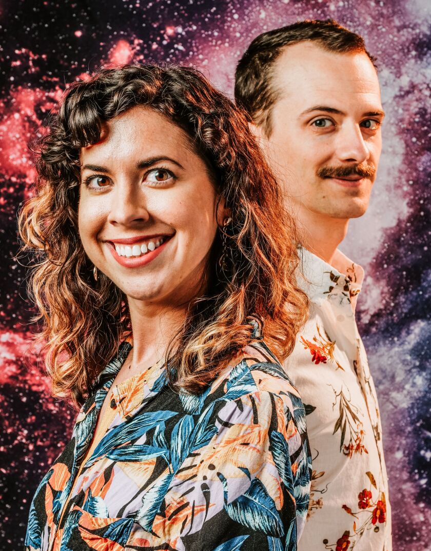 REACH podcast hosts Meredith Stepien (left) and Brian Holden (right) pose for a promotional photo.