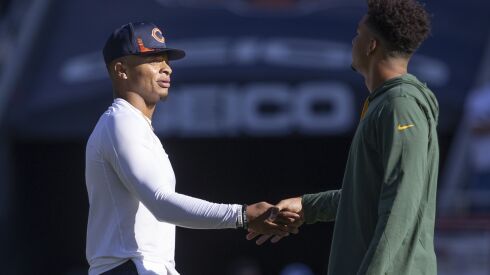 Bears quarterback Justin Fields (left) greeting Packers quarterback Jordan Love before a 2021 game at Soldier Field.