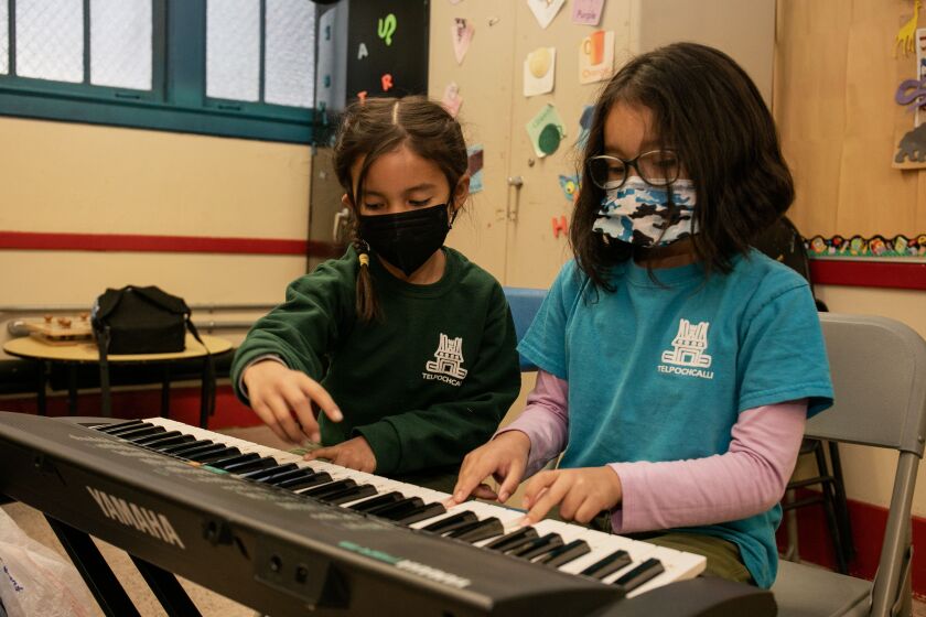 People’s Center for Cultural and Contemporary Arts students Marina Velazquez (right), 7, and Carmen Aldana Banda, 6, play the keyboard during a rehearsal Thursday at the Dvorak Fieldhouse in the Pilsen neighborhood.