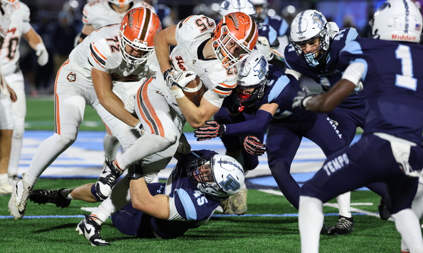 Hersey's Travis Jackson (25) running hard in the face of Prospect's defense.