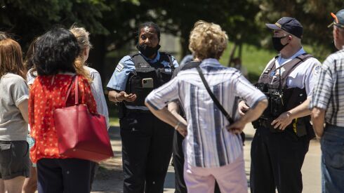 Officer Ramona Stovall and Sgt. Christopher Schenk meeting with community residents about safety and policing June 4, 2021, near Oz Park.