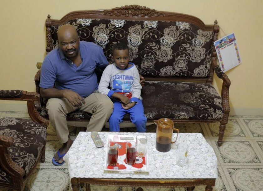 Sudanese activist Tayeb Ibrahim, who hopes to see family living in Iowa, watches television with his son Mohammed, in Cairo, EgyptJune 28, 2017. Dozens of Sudanese activists living in Egypt as refugees now face legal limbo in Egypt after the Supreme Court
