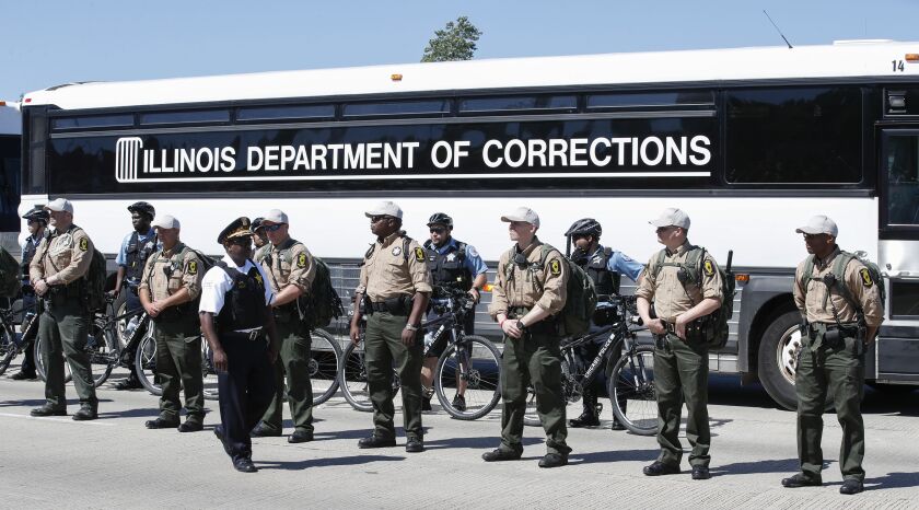 State Department of Corrections buses lined the interstate to form a barrier for the lanes the marchers walked in during the march on the Dan Ryan Expressway. (Photo by Kamil Krzaczynski/Getty Images)